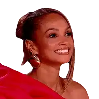 a woman wearing a red top and earrings smiles