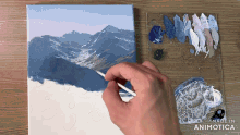 a person is painting a mountain landscape with the words made in animotica visible