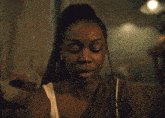 a close up of a woman 's face with the word l.. on her shoulder