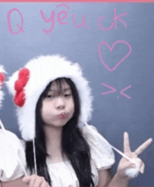 a girl wearing a white hat with a red bow on it