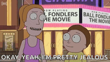 a couple of cartoon characters standing in front of a sign that says " ball fondlers the movie "