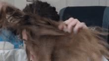 a woman 's hair is blowing in the wind with the letter r visible