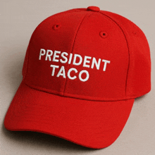 a red baseball cap says president taco on it