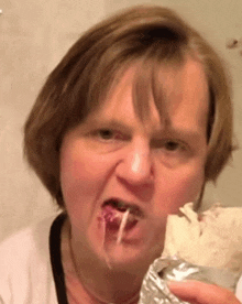 a close up of a woman eating a burrito
