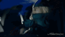 a woman is sitting in a car with her face covered in a scarf .