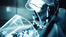 a person wearing a helmet and gloves is looking down