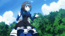 a girl in a black and blue dress is standing in front of trees