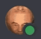 a close up of a man 's face with a green circle in the middle .