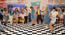 a group of people are dancing in a diner with a sign that says pep rally on it