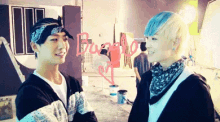 two young men are standing next to each other with the word buzz on the wall