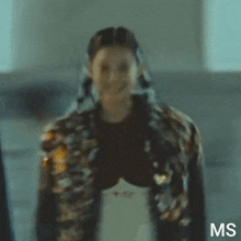 a close up of a woman wearing a jacket with buttons on it .