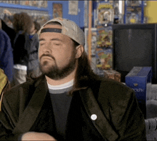 a man with long hair and a beard is wearing a hat and a jacket
