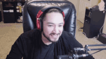 a man wearing headphones is sitting in a chair