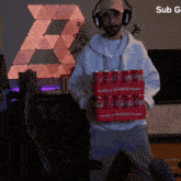 a man wearing headphones is holding a box of coca cola