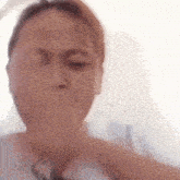 a close up of a person making a funny face with their hand .