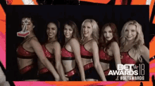 a group of cheerleaders are standing in front of a bet awards banner