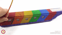 a person is playing with a toy made of magnets