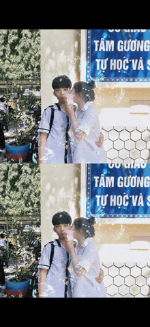 a boy and a girl blowing bubbles in front of a sign that says tam gương