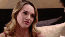 a woman in a red bra looks at the camera