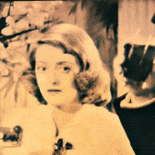 a black and white photo of a woman in a white dress