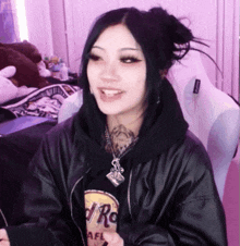 a girl wearing a hard rock t-shirt and a black leather jacket