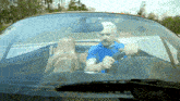 a man with a beard is driving a car