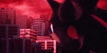 shadow the hedgehog is standing in front of a city in a video game .