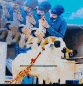 a man is holding a chicken and a dog with blood coming out of it