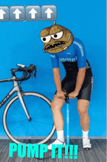 a man with a cartoon face on his head pumping a bicycle tire