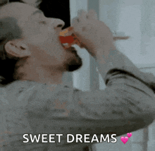 a man drinking from a glass with the words sweet dreams written on the bottom