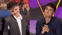 a man in a suit and a man in a blue shirt are clapping