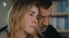 a man and a woman are sitting next to each other and the woman is crying .