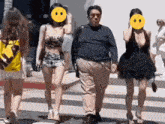 a man and two women are walking down a street with a smiley face on their faces
