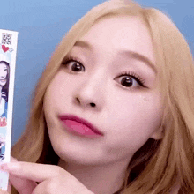 a close up of a woman holding a card with a picture on it .