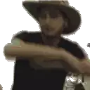 a man wearing a cowboy hat and a black shirt is holding a bottle .