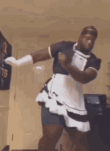 a man is dancing in a maid costume .