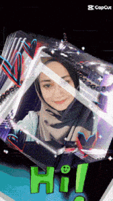 a woman in a hijab is in a cube with the word hi in green