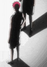 a couple of people standing next to each other with their shadows .