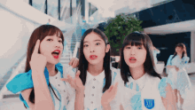 three girls wearing white shirts with the letter xiv on the front