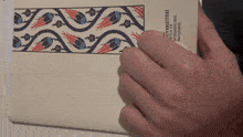 a hand is holding a book that says ' üniversitesi ' on the front