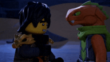 two lego figures standing next to each other with one wearing a green scarf