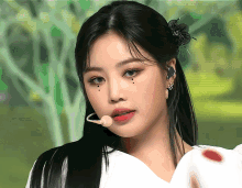 a close up of a woman with a microphone in her mouth