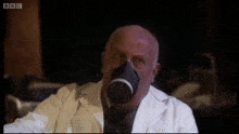 a man wearing a gas mask and a bbc logo on the bottom left