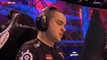 a man wearing headphones with the word blacklyte on the back