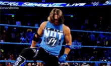a wrestler in a blue shirt that says not pi