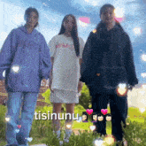three girls are standing next to each other with the word tisinunu on the bottom right