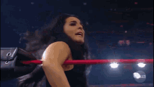 a woman in a wrestling ring with axstv on the bottom
