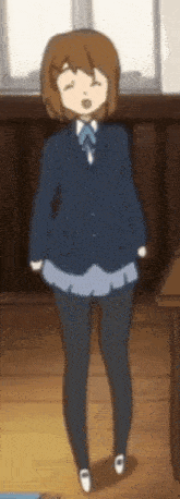a girl in a school uniform is standing with her eyes closed