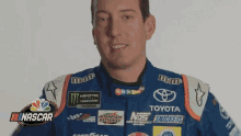 a man is wearing a nascar racing uniform