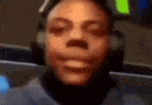 a close up of a person 's face wearing headphones .